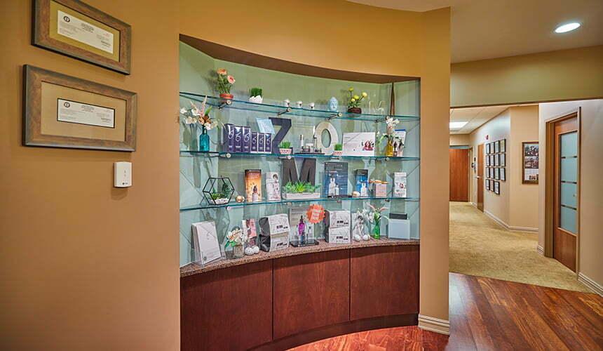 Display cabinet with products in hallway at Movassaghi Plastic Surgery in Eugene