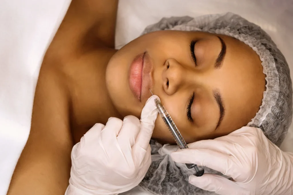 Woman getting lip filler injections at a medical spa