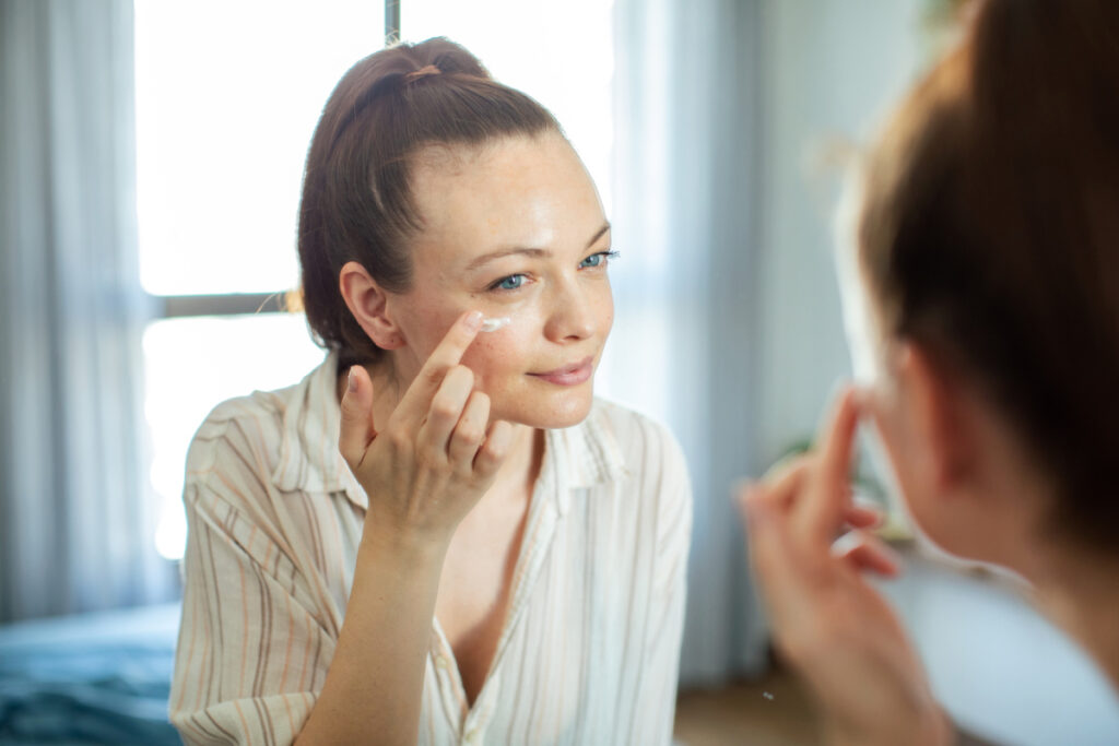 Woman applying medical-grade sunscreen