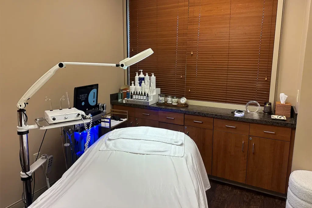 Clean cosmetic treatment room with equipment and supplies.