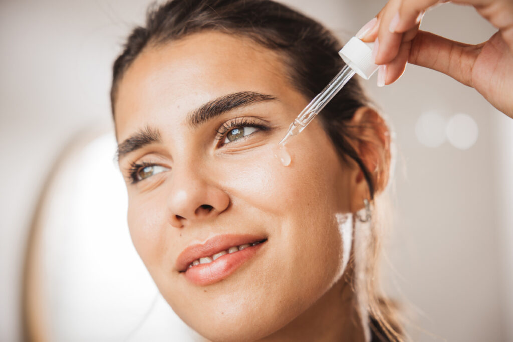 Woman applying skin serum