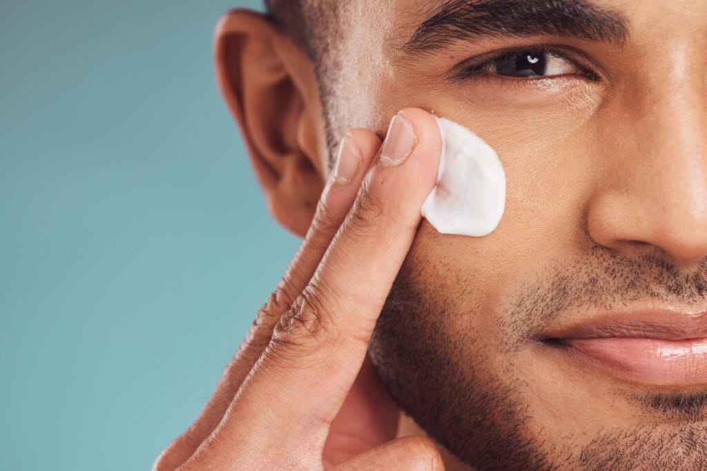 Close up of man applying facial cream