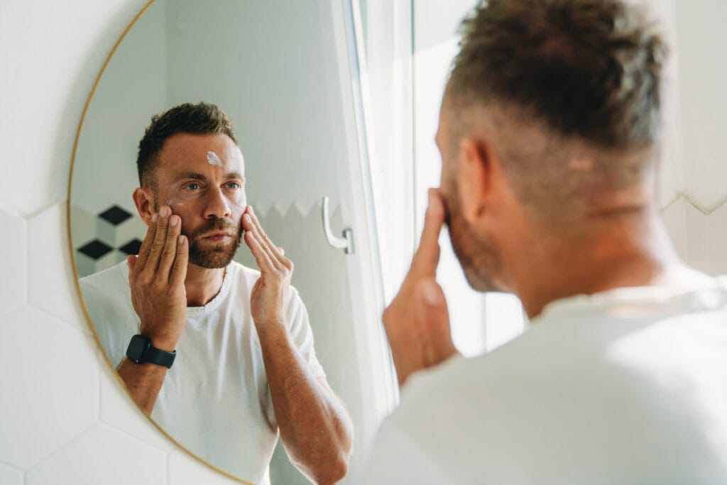 Man applying sunscreen before outdoor run