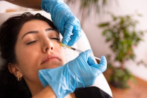 Woman getting under-eye filler injections