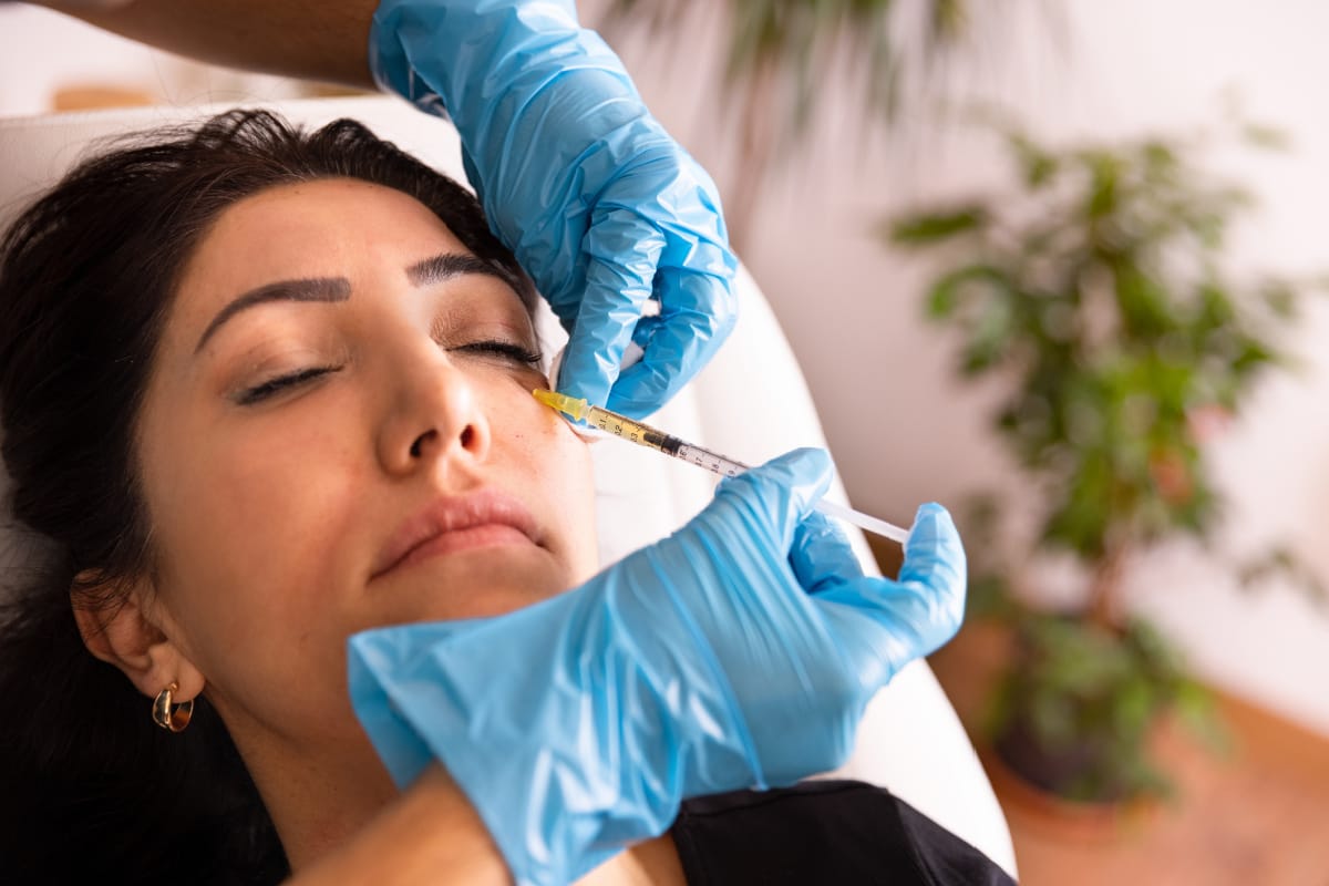 Woman getting under-eye filler injections